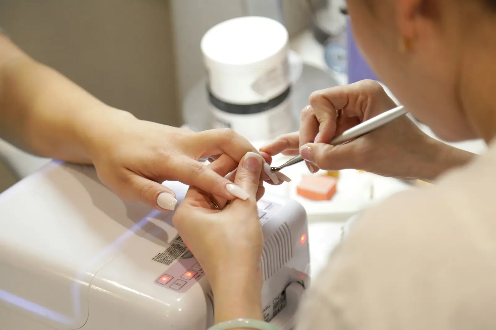 A technician filing a client's nails