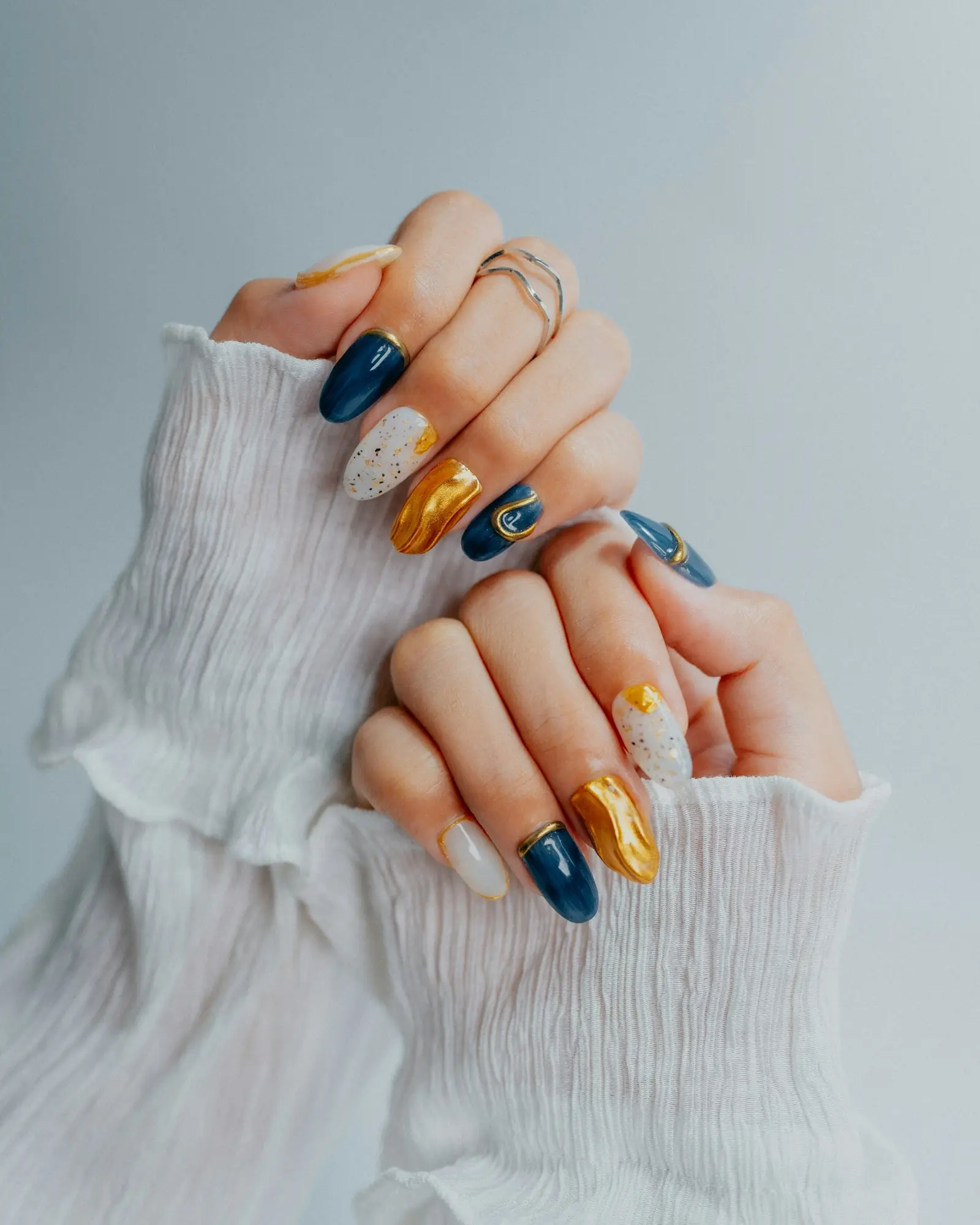 Navy, gold and white hand-painted nail art